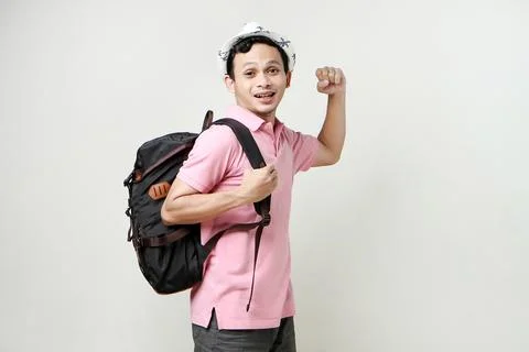Asian man backpackershowing strength gesture with arms. digital nomad and t.. Stock Photos