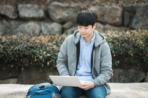 Asian man backpacking using laptop Stock Photos