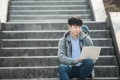 Asian man backpacking using laptop Stock Photos