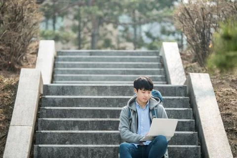 Asian man backpacking using laptop Stock Photos