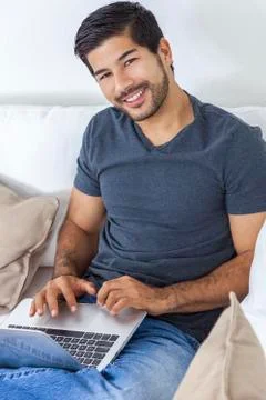 Asian man with beard using laptop computer Stock Photos