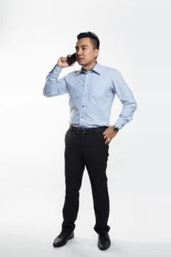 Asian man being angry while talking over the phone Stock Photos