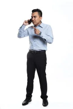 Asian man being angry while talking over the phone Foto stock