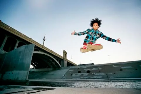 Asian man break dancing under overpass 스톡 사진