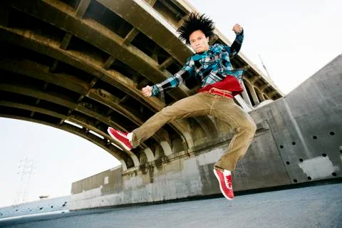 Asian man break dancing under overpass 스톡 사진