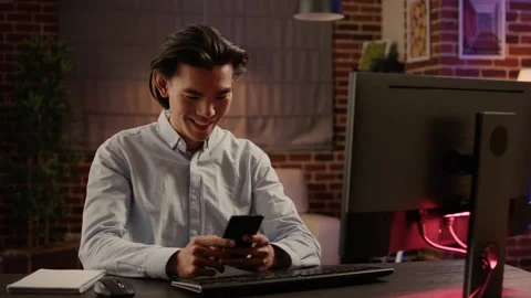 Asian man browsing internet on smartphone and texting messages Stock Footage 200370020