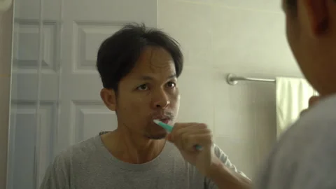 Asian man brushing teeth in bath room. Stock Footage 300155887