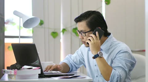 Asian Man Calling and Typing at Office - 4K Resolution Video stock 60429517