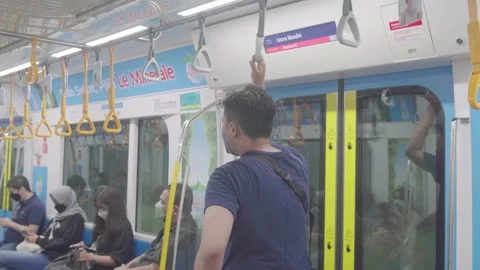 An asian man is changing his hand from one hand strap to another Stock Footage 224257169