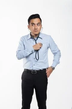Asian man checking himself with a stethoscope Stock Photos