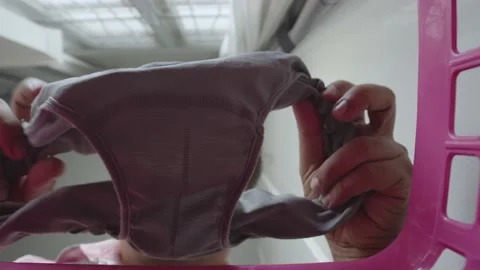 Asian man checking underpants before put in a clothes basket. Stock Footage 237003162