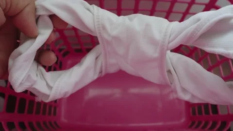 Asian man checking underpants before put in a clothes basket. Stock Footage 237003171