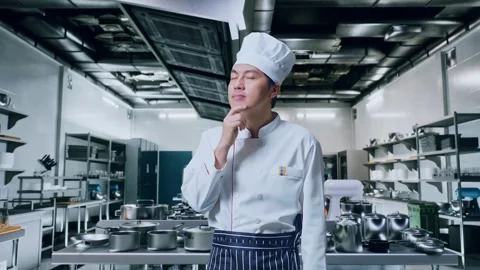 Asian Man Chef Thinking About Something And Looking Around In Kitchen Stock Footage 273241325