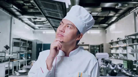 Asian Man Chef Thinking About Something And Looking Around In Kitchen Stock Footage 273242664