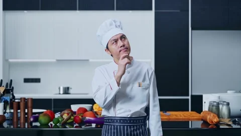 Asian Man Chef Thinking And Looking Around In Home Kitchen Stock Footage 271156548