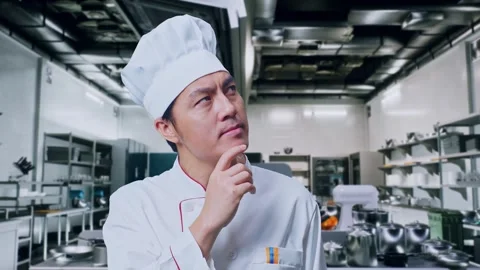 Asian Man Chef Thinking Then Raising His Index Finger In Kitchen Stock Footage 273242640