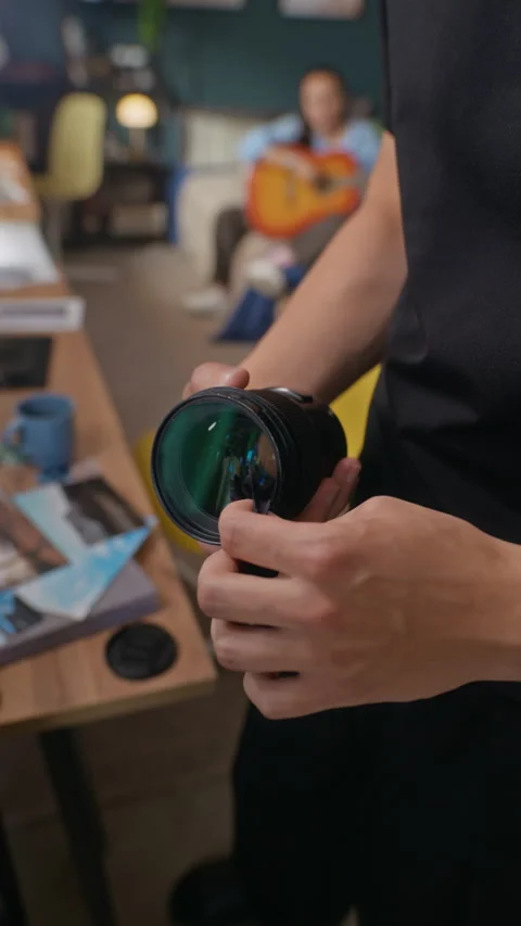 Asian Man Cleaning Professional Camera Lens in Creative Studio Stock Footage 341953590