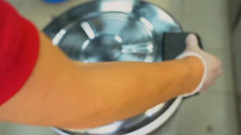 Asian man cook open a silver pan with tasty cooked white rice for sushi rolls. Video stock 119979086