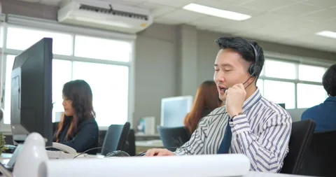 Asian man is customer support agent or call center with headset Видео 165203898