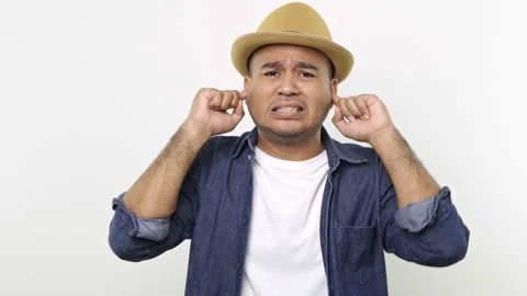 Asian man in denim jacket put his hand on his ears on camera. Suffer guy from mu Stock Footage 144652356
