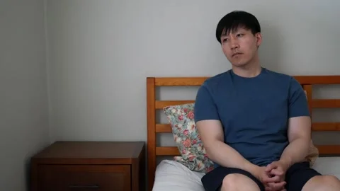 Asian man with depression sitting on the bed Stock-Footage 248665478