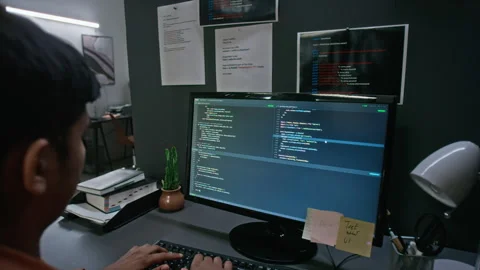 Asian Man Developing Software Code on Desktop Computer at Night Stockbeeldmateriaal 348355632