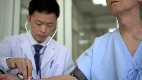 Asian man doctor checking on eldery old patient at hospital clinic 4k Stock Footage 281237743
