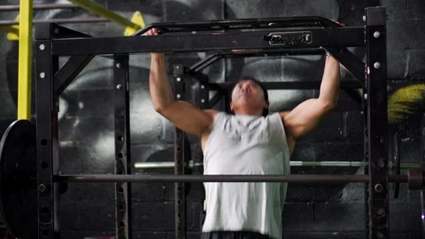 Asian Man Does Pull-ups In Gym On Fitness Program, 4K Strength Video stock 106629737
