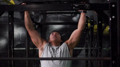 Asian Man Does Pull-ups In Gym On Fitness Program, 4K Strength Video stock 106629819