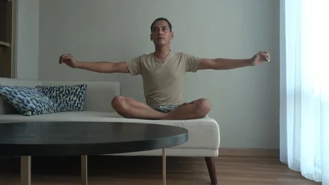 Asian man doing an exercise in the living room Stock Footage 226942271
