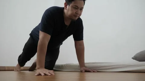 Asian man doing push ups in his bed room, exercise after waking up in the m.. Video stock 296004468