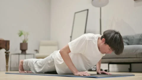 Asian Man doing Pushups on Yoga Mat at Home Video stock 157325500