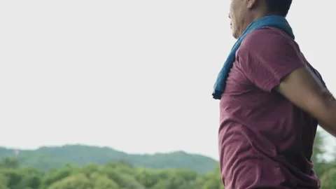 Asian man doing standing arms swing exercise to warm up at the park Video stock 135995329