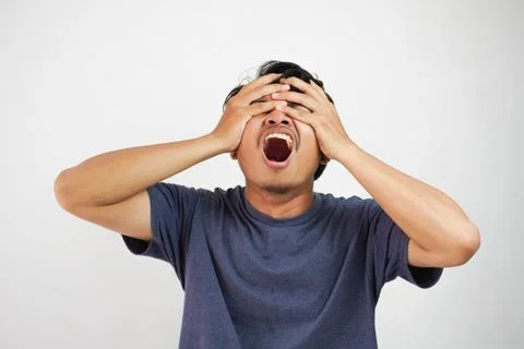 A Asian man doing wrong or mistake with both hands covering eyes isolated on  Stock Photos