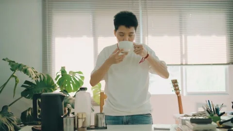 Asian man drinking coffee ready to work from home at home office in the morning. Stock Footage 247987782