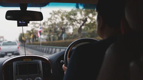 Asian man driving through light traffic congestion during the evening rush hour  Stock-Footage 107480016