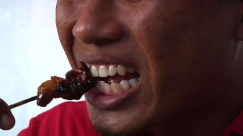 Asian man eats satay and rice Stock Footage 34457706