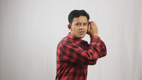 Asian man eavesdropping on people's Video stock 320005202