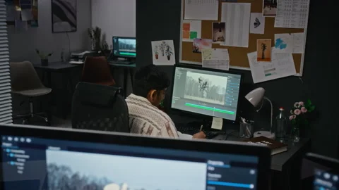 Asian Man Editing Visual Effects on Computer in Creative Studio Stock Footage 348359555