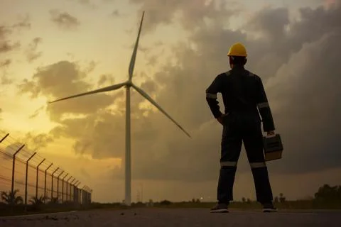 Asian man engineer preparing and checking of a wind turbine with safety . Stock Photos