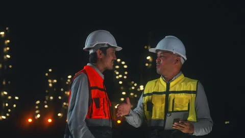 Asian man engineers shaking hands together at petroleum oil refinery. Video stock 270459781