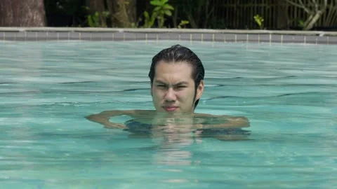 Asian man enjoying on a pool. Slow motion Stock Footage 337739460