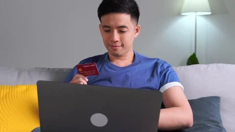Asian man enjoying using credit card for online shopping Video stock 170625201