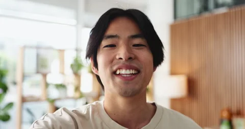 Asian man, face and hello with video call in living room for online chat, Stock Footage 327450350