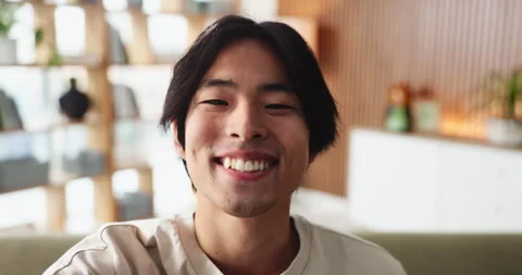 Asian man, face and wave with video call in living room for online chat, Stock Footage 327450820