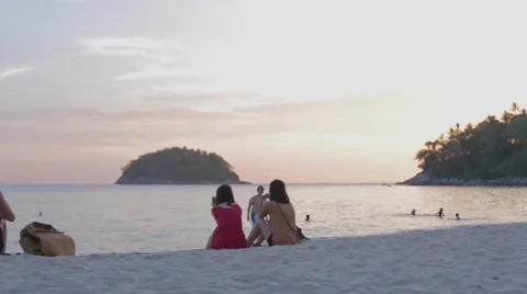 Asian man in fedora hat returns from ocean Stock Footage 50215033