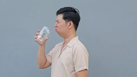Asian man feel sensitive teeth after drinking cold. Dental health problems Stock Footage 293652135