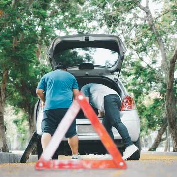 Asian man find tools in the car for car repair after a car breakdown on stree Stock Photos