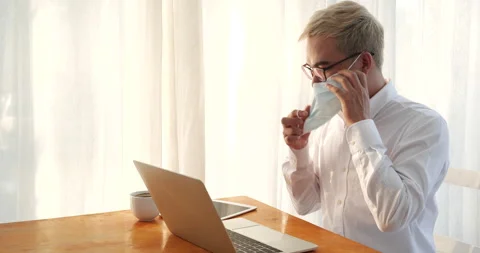 Asian man freelance using laptop at home office desk. man reading financial grap Stock Footage 234152255