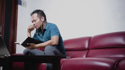 Asian man freelancer talking at web virtual meeting on laptop camera. 스톡 동영상 281425217